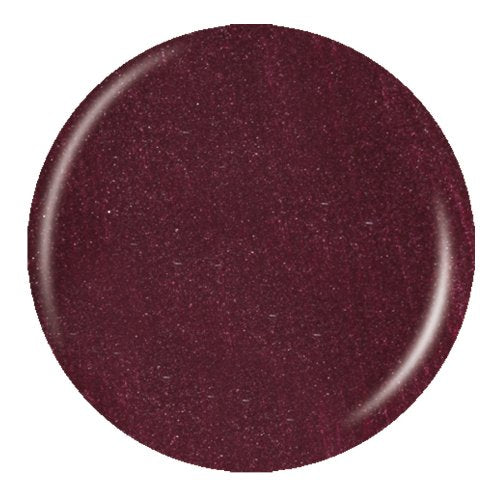 A circular nail polish swatch of a sparkling deep plum shimmer polish on a plain white background.