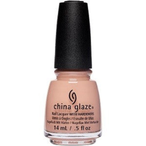 A bottle of China Glaze nail polish in a light sandy beige color with a black cap.