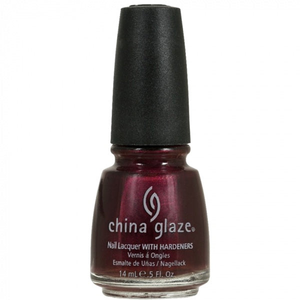 Bottle of deep magenta red China Glaze nail polish with a black cap on a white background