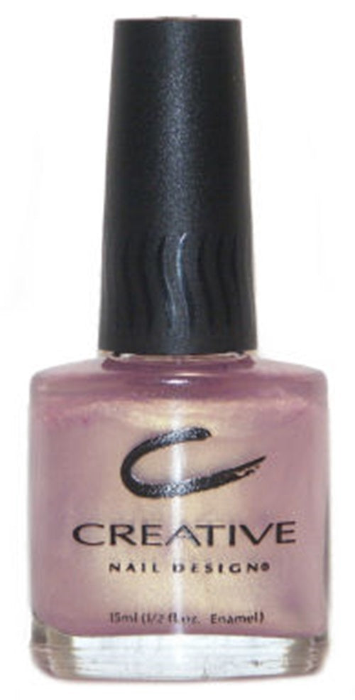 A bottle of Creative Nail Design nail polish in a semi-sheer warm gold color with a subtle lavender flash.