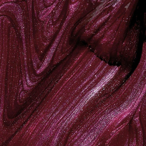 Close-up of burgundy red shimmery nail polish swatch with brush.