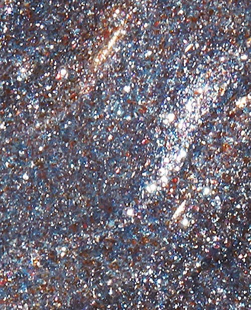 Close-up of gray glittery nail polish swatch.