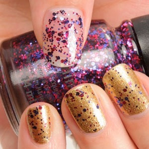 Close-up of a hand with glittery gold and multicolor nail polish.