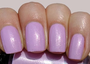 Nails with pink nail polish on a neutral background