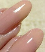 Sheer pink nail polish swatch on nails.