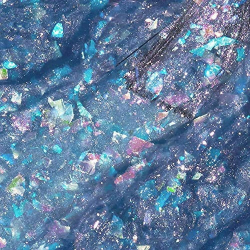 Close-up of glittery blue and purple nail polish swatch with brush.