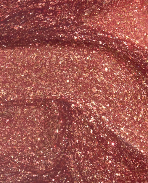 Close-up of a glittery, metallic coppery pink naiil polish swatch