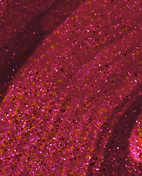 Close-up of pink glittery nail polish swatch