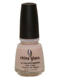 A bottle of China Glaze nail polish in a light peach-toned pink creme color.