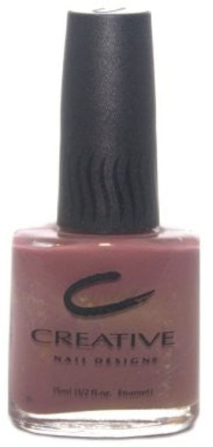 Nail polish bottle with pink color and black cap on a white background