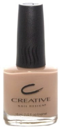 A bottle of Creative Nail Design nail polish in a sheer nude beige color, with the brand logo and product information on the label.
