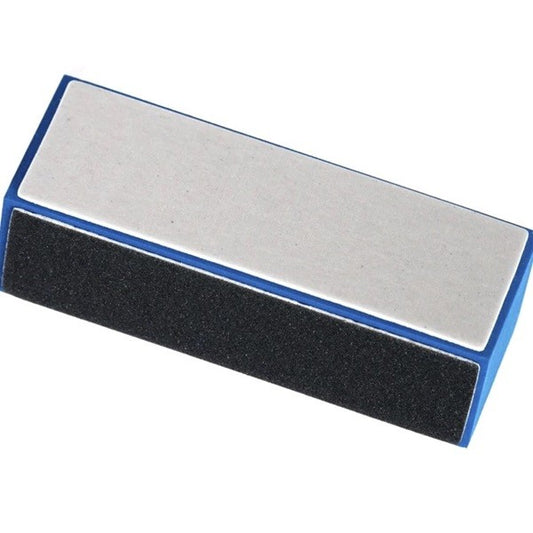 A 3-way nail buffer block in white, black, and gray colors, used for shining and buffing nails.