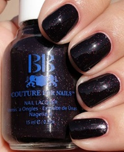 blackened plum nail color with subtle red micro-glitter painted on nails, with BB Couture bottle.