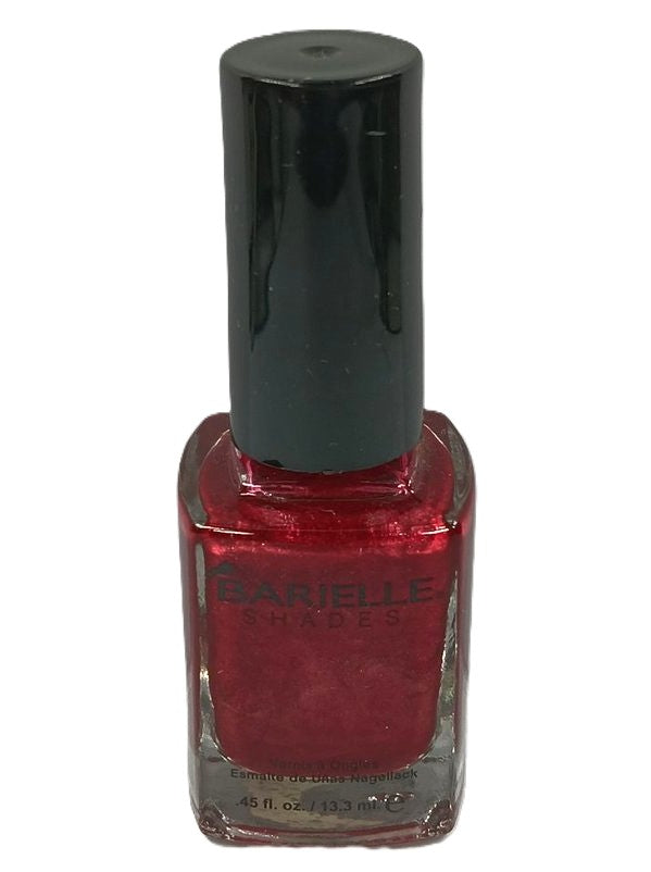 A bottle of Barielle nail polish in a medium to deep red shade with red pearlescent shimmer,and a black cap.