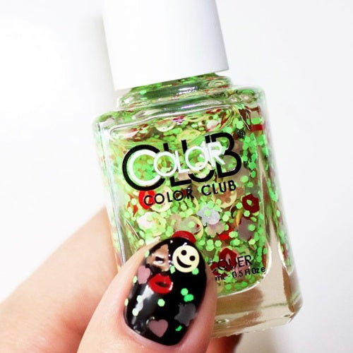 Nail polish bottle with green, red and yellow emoji glitter and nail polish swatch on nail.