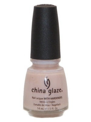 A bottle of China Glaze nail polish in a light peach-toned pink creme color with a black cap.