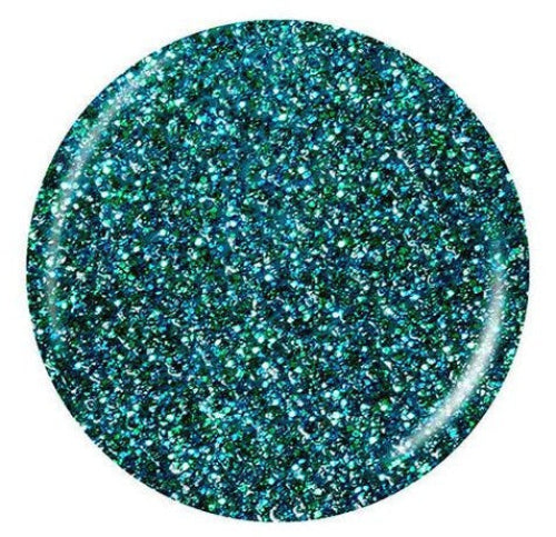 A circular close-up of a glittery green and turquoise nail polish swatch on a plain white background.