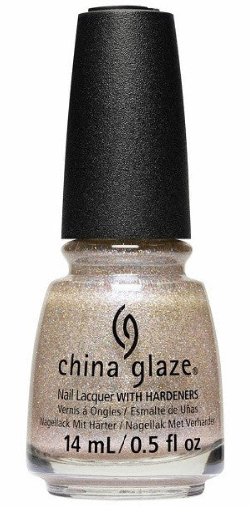 A bottle of China Glaze nail polish in a light champagne color with gold micro-glitter and pink undertones, with a black cap.