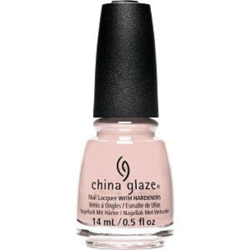A bottle of China Glaze nail polish in a light sandy nude creme color, with a cap and branding visible.