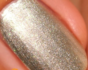 Close-up of a glittery silver nail polish swatch.