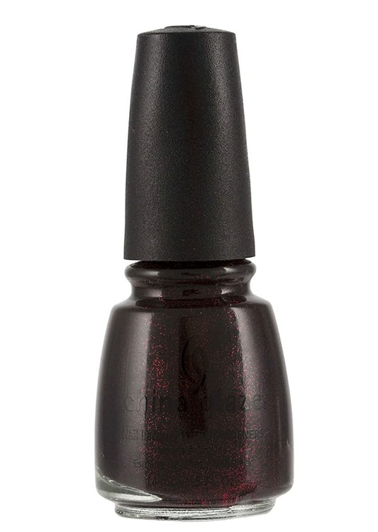 China Glaze black translucent nail polish bottle with red glitter, and a black cap.
