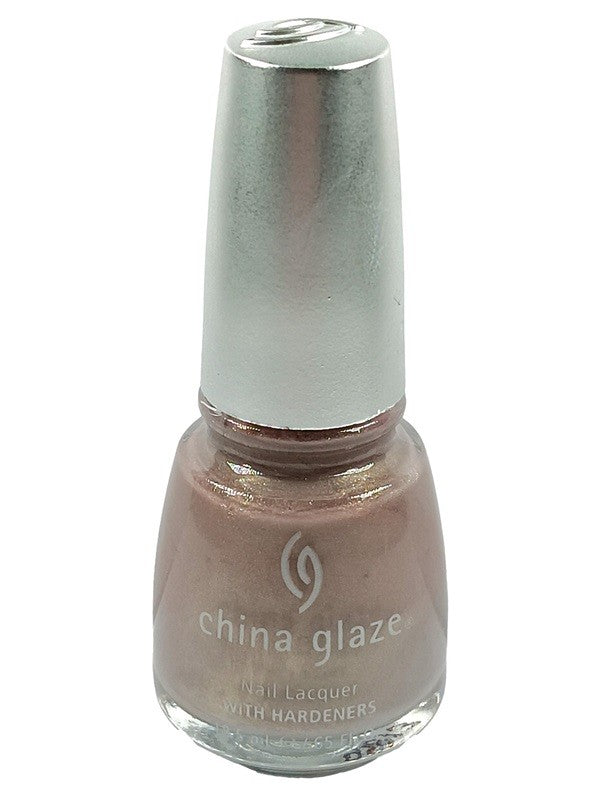 A bottle of China Glaze nail polish in a light taupe color with a hint of lilac and gold shimmer, labeled as 'Orchid Shadow 2214'.