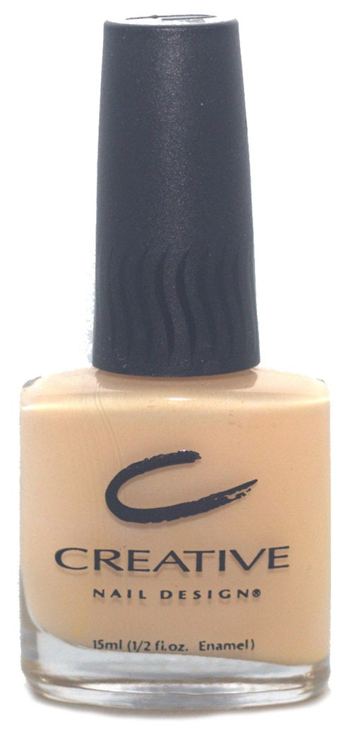 A bottle of Creative Nail Design nail polish in a light pinky peach color, with a black cap and a label with the brand logo.