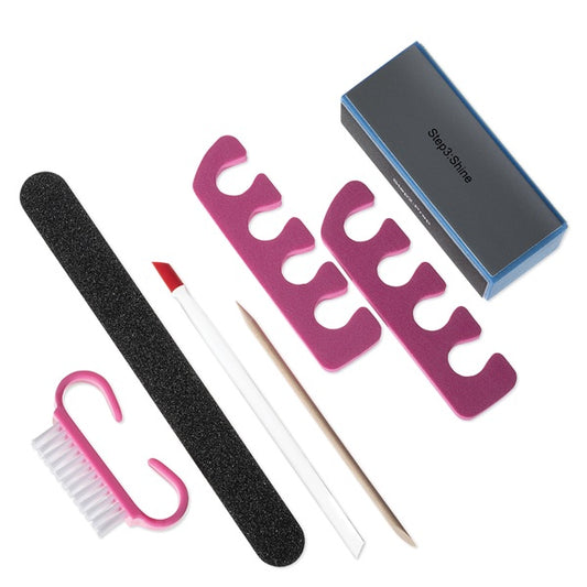 Set of nail care tools including a file, brush, and pink stand on a white background.