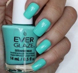 EverGlaze bright turquoise nail polish swatch on nails, holding an EverGlaze bottle.