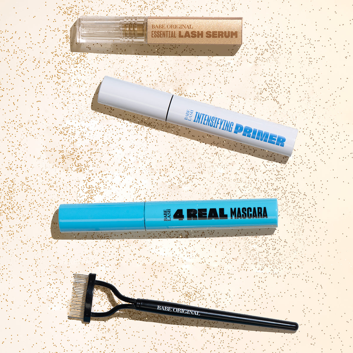 Set of makeup products including a lash serum, intensifying primer, and mascara on a textured beige background.