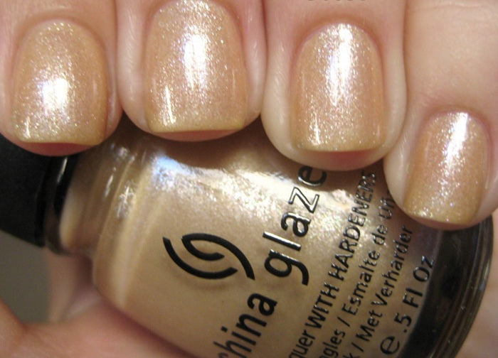 Light beige nail swatch on nails with China Glaze nail polish bottle.