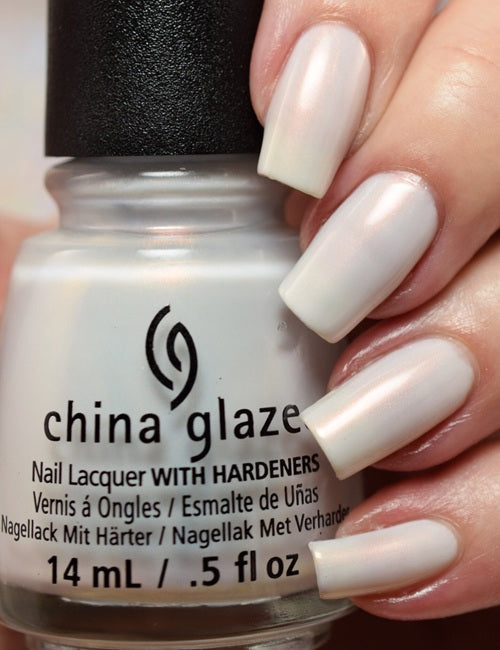 China Glaze nail polish bottle held by a hand with white nails