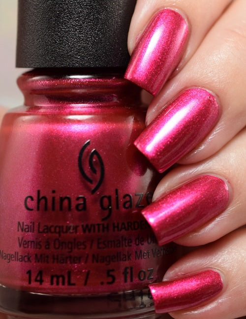 China Glaze nail polish bottle with a hand displaying bright pink nails
