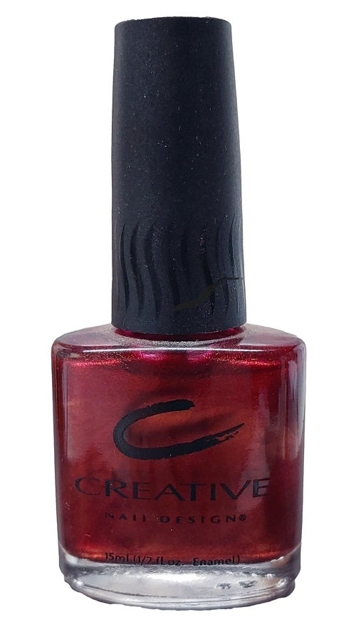 A bottle of Creative Nail Design nail polish in Dark Secret color with a shimmer finish.