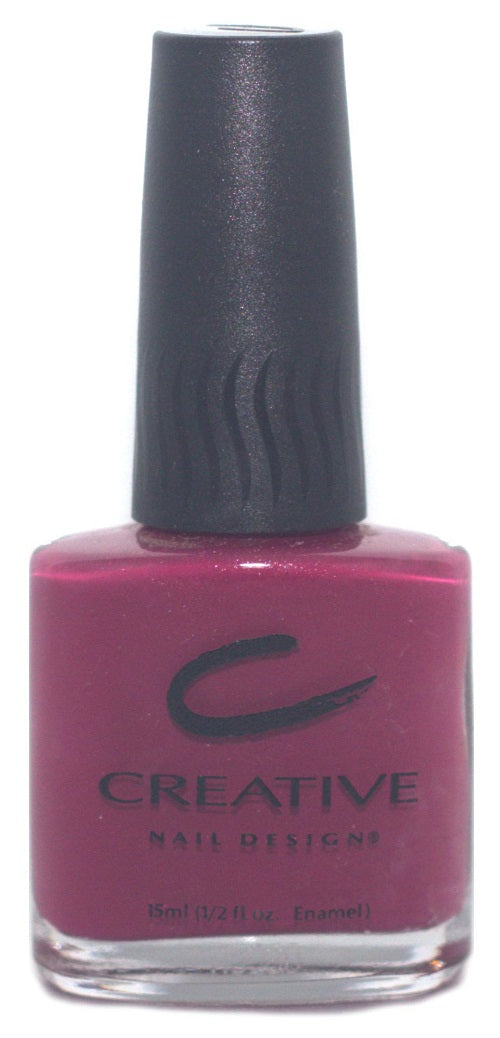 A bottle of Creative Nail Design nail polish in a vivid deep pink berry color with a subtle micro-shimmer, labeled as part of the CND Exhibit Collection.