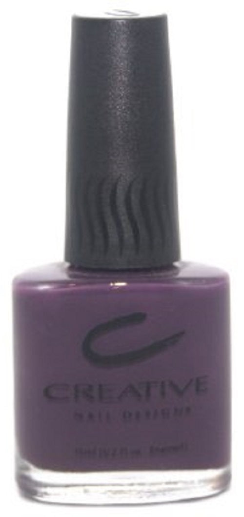 A bottle of Creative Nail Design nail polish in dark eggplant purple color, with a ridged cap.