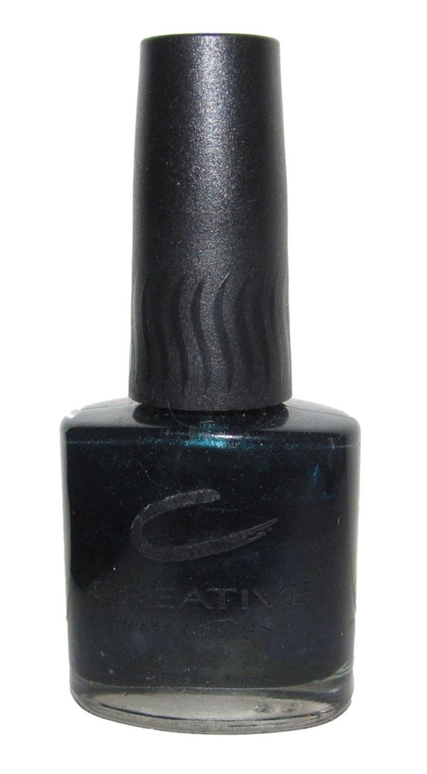 A bottle of Creative Nail Design nail polish in blackened teal color with teal shimmer.