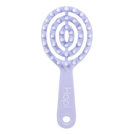 Purple hairbrush with a textured head on a white background