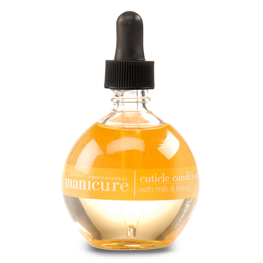 A bottle of Cuccio Naturale Revitalizing Cuticle Oil with a dropper cap, labeled for professional cuticle care with milk and honey.