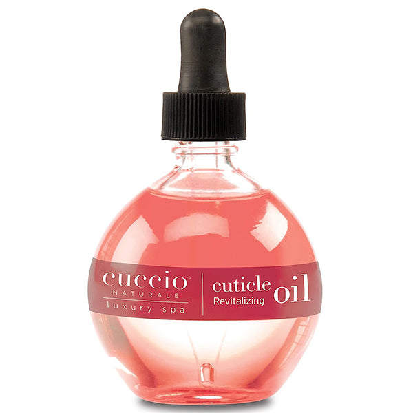 A bottle of Cuccio Naturale Revitalizing Cuticle Oil with a dropper cap, labeled for professional cuticle care with pomegranate and fig scent.