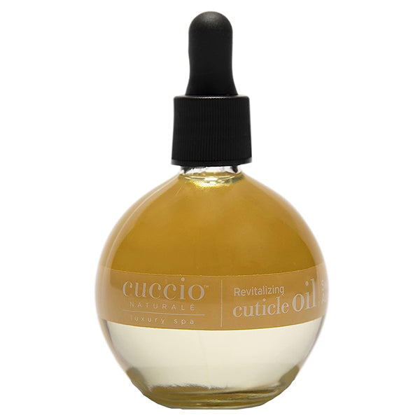 A bottle of Cuccio Naturale Revitalizing Cuticle Oil with a dropper cap, labeled for professional cuticle care with sweet almond scent.