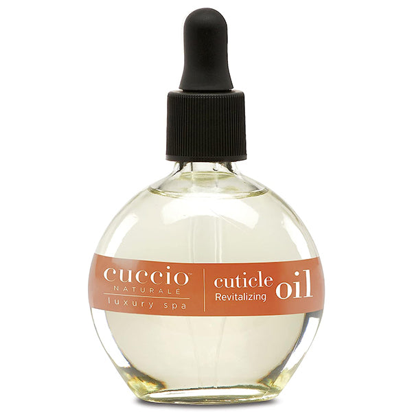 A bottle of Cuccio Naturale Revitalizing Cuticle Oil with a dropper cap, labeled for professional cuticle care with vanilla bean and sugar scent.