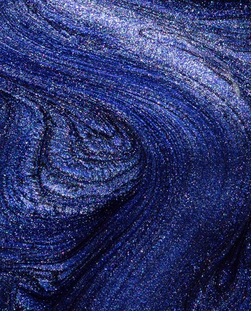 Close-up of blue shimmery nail polish swatch
