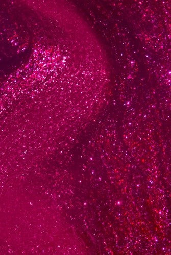 Close-up of a pink glittery nail polish swatch