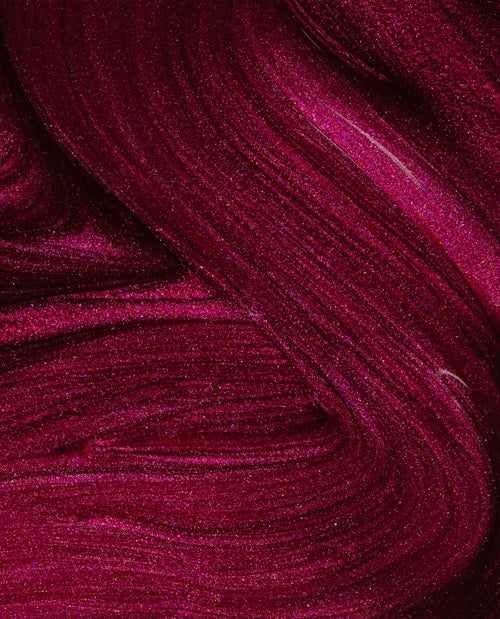 Close-up of dark burgundy red shimmer nail polish swatch