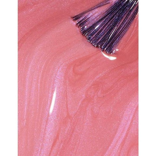 Close-up of pink nail polish with a brush on a pink background