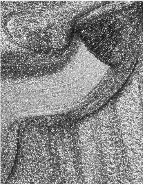 Close-up of shimmery gray silver nail polish swatch.