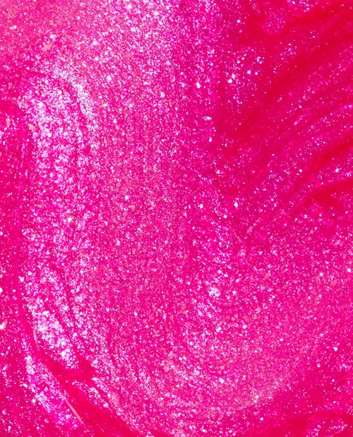Close-up of pink glittery nail polish swatch