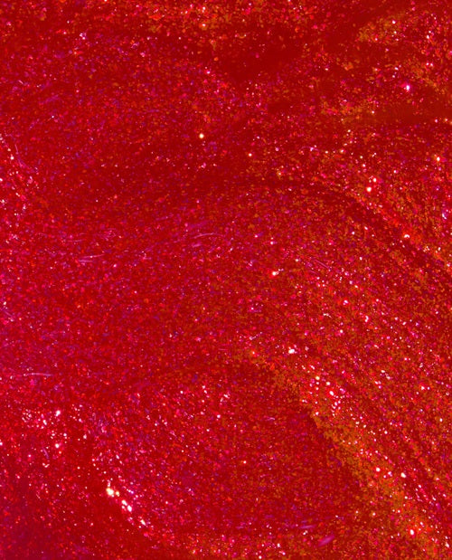 Close-up of red glittery nail polish swatch