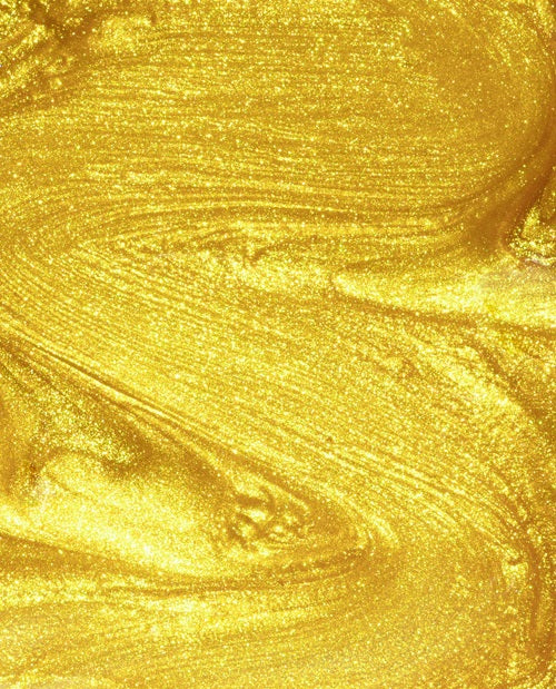 Close-up of gold shimmer nail polish swatch.
